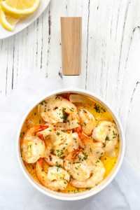 Garlic prawns with chives and lemon.  Overhead view.