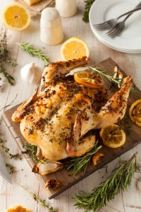 Homemade Lemon and Herb Whole Chicken on a Cutting Board
