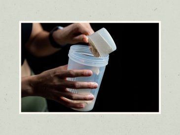 Pouring creatine into shaker cup.